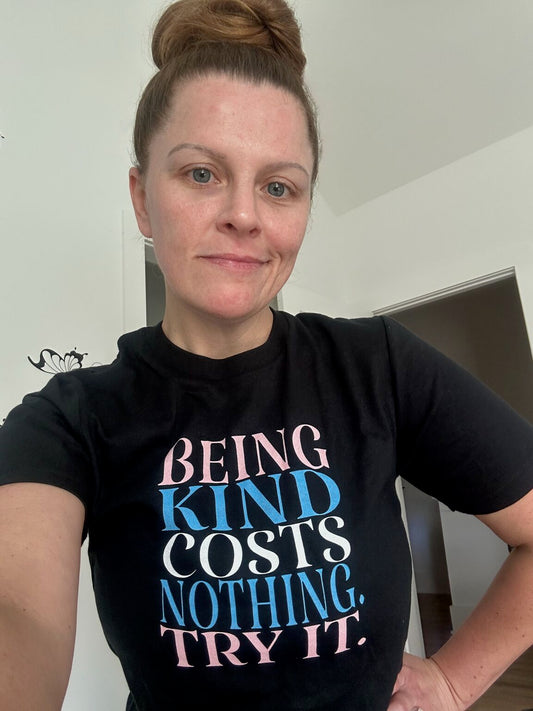Selfie of satisfied customer wearing her new "Being Kind Costs Nothing. Try It." t-shirt from Real Belonging