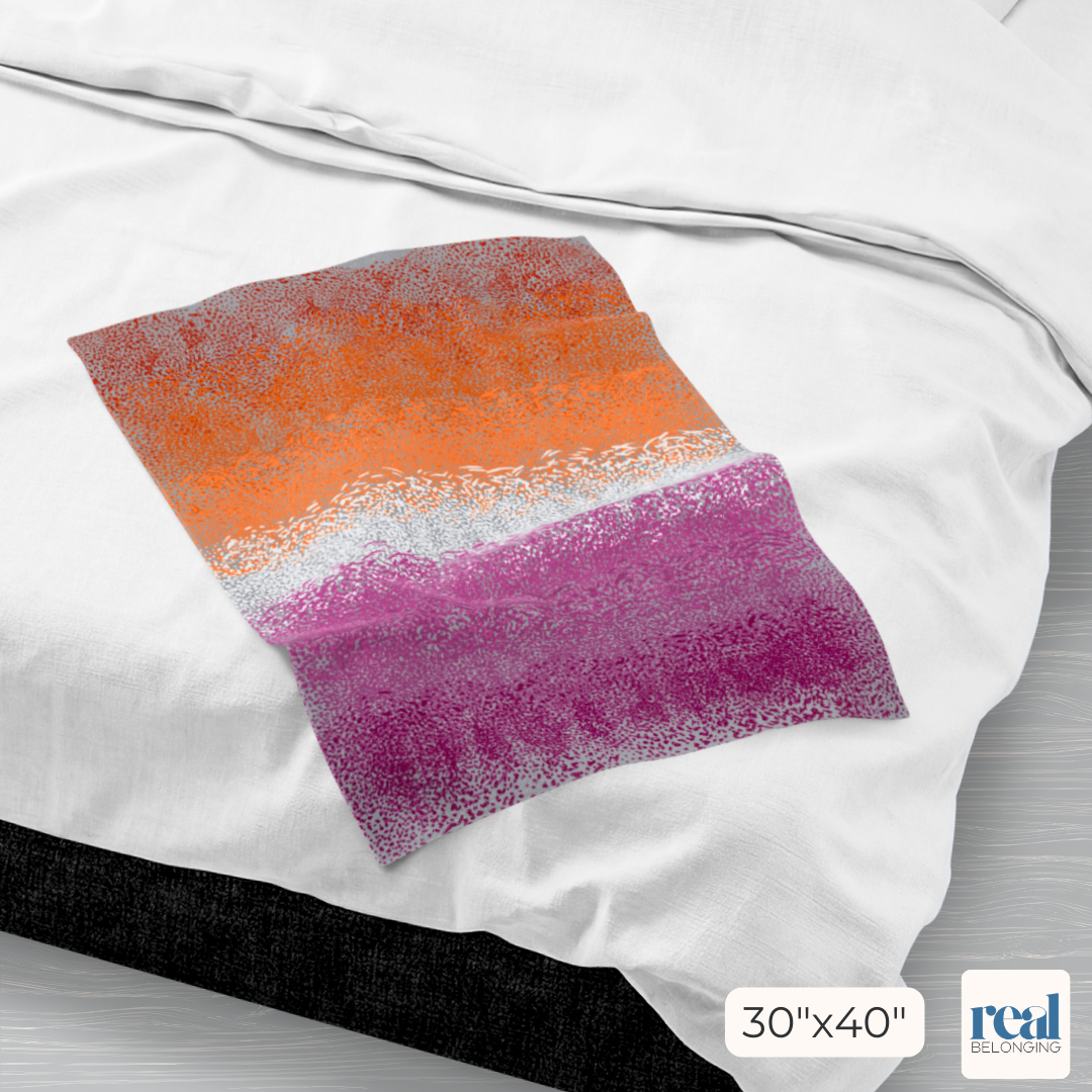 Colorful textured fabric on a white bedding background with Real Belonging brand logo in the bottom corner