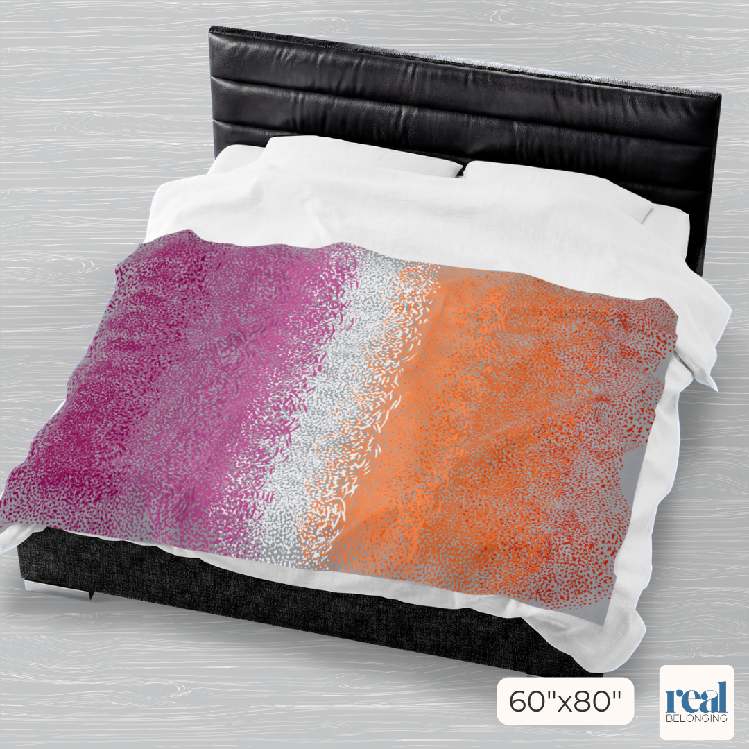 Colorful abstract patterned comforter on a bed with a headboard.