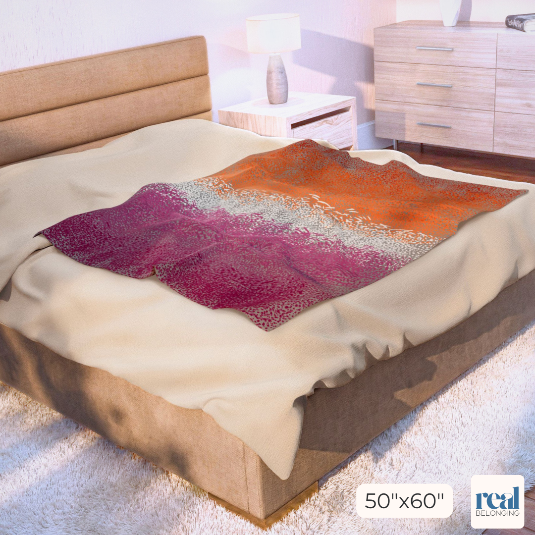Colorful abstract patterned blanket on a bed in a bedroom setting