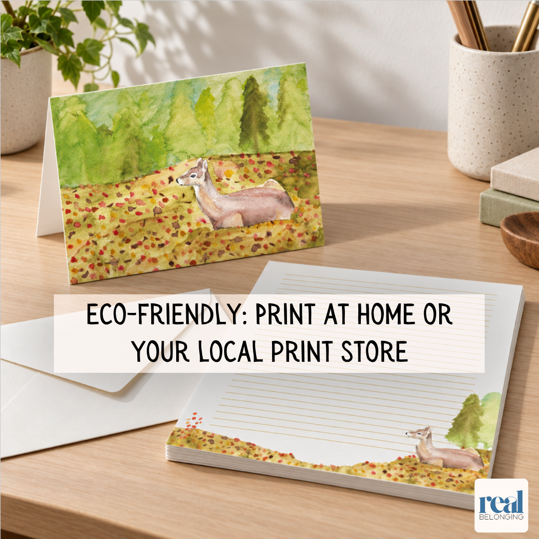 Stack of printable eco-friendly watercolor letter paper, a folded greeting card, and an envelope on a wooden desk