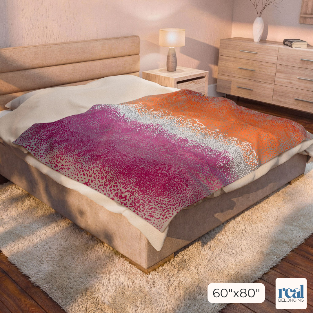 60"x80" gray blanket with Lesbian colored Organic Pride design print in swirling dots across the entire blanket. Blanket is laying across a King size bed for perspective in a neutral tan room.
